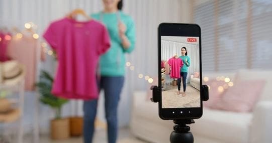 A person taking a picture of a person in front of a phone

AI-generated content may be incorrect.